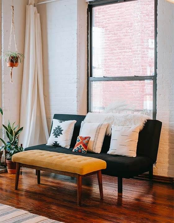 Brick condo with white walls and couch near St. Petersburg, FL.