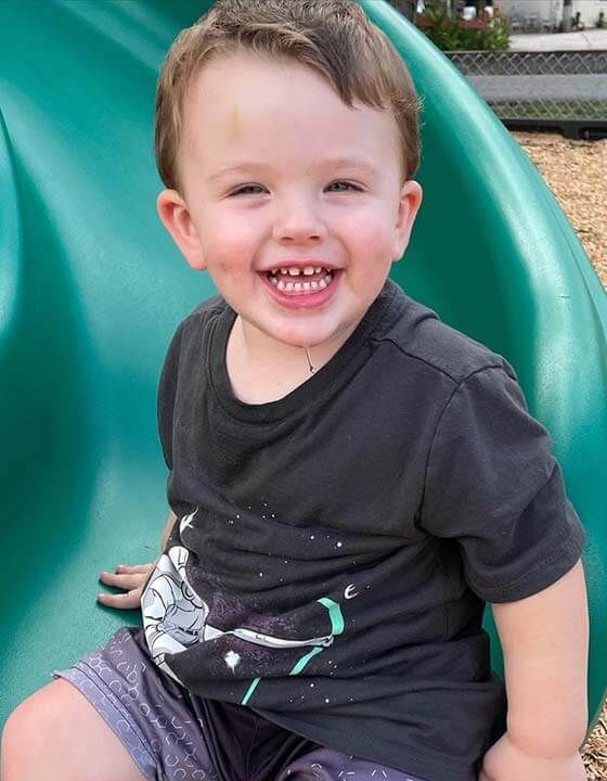 Elliot on playground slide in Florida.