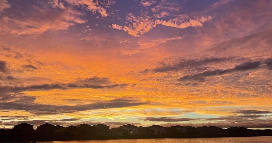 Florida sunset over a row of houses in a neighborhood.